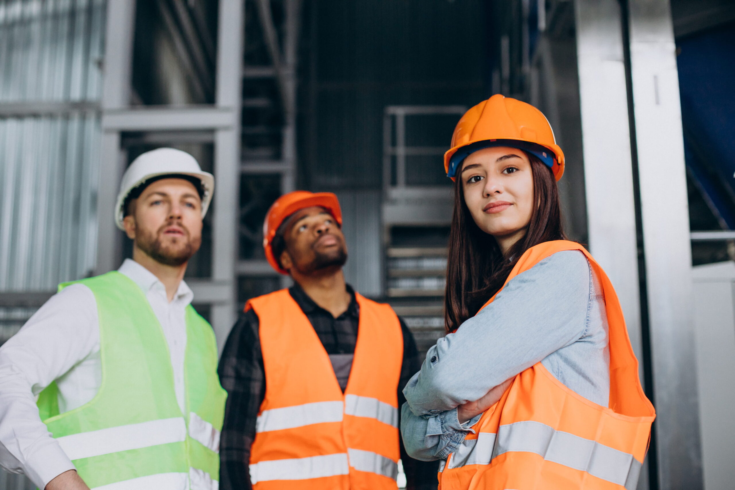 Factory workers wearing protective helmets